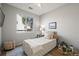 Bright bedroom with a large window letting in natural light, complemented by neutral tones and simple, elegant decor at 19302 E 58Th Pl, Aurora, CO 80019