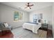 Bright bedroom features a ceiling fan, a plush rug, and a chair by a window at 19302 E 58Th Pl, Aurora, CO 80019