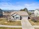 Charming single-story home featuring a well-manicured lawn, inviting entrance, and a spacious two-car garage at 19302 E 58Th Pl, Aurora, CO 80019