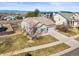 Charming single-Gathering home with tile roof, lush front lawn, two-car garage, and mountain views at 19302 E 58Th Pl, Aurora, CO 80019