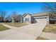 Charming single-story home with a well-maintained lawn and a two-car garage at 19302 E 58Th Pl, Aurora, CO 80019