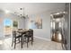 Bright kitchen with dining area, tile floors, and sliding glass door leading to the backyard at 19302 E 58Th Pl, Aurora, CO 80019