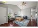 Bright living room with a vaulted ceiling, hardwood floors, stylish furnishings, and ample natural light at 19302 E 58Th Pl, Aurora, CO 80019