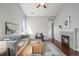 Inviting living room with hardwood floors, a ceiling fan, decoratively painted walls and fireplace at 19302 E 58Th Pl, Aurora, CO 80019