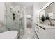 Modern bathroom with glass shower, double vanity, and luxurious marble tile throughout at 6212 Kilmer Loop # 202, Golden, CO 80403