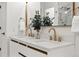 Bright bathroom features double sinks with quartz countertops and gold fixtures at 6212 Kilmer Loop # 202, Golden, CO 80403