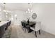 Bright dining room with a dark wood table, seating for six, and modern lighting at 6212 Kilmer Loop # 202, Golden, CO 80403