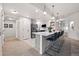 Bright kitchen features stainless steel appliances, white cabinets, and an island with seating for four at 6212 Kilmer Loop # 202, Golden, CO 80403