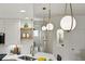This view highlights the kitchen's open shelving, modern lighting and marbled countertops at 6212 Kilmer Loop # 202, Golden, CO 80403