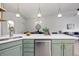 Bright kitchen featuring an island with green cabinets, quartz countertops, and pendant lighting at 6212 Kilmer Loop # 202, Golden, CO 80403