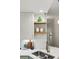 Kitchen featuring stainless faucet, custom wood shelves, and quartz countertops at 6212 Kilmer Loop # 202, Golden, CO 80403