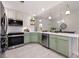 Charming kitchen featuring modern appliances, stylish sage cabinets, and bright countertops at 6212 Kilmer Loop # 202, Golden, CO 80403