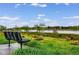 Scenic view from a bench overlooking a serene lake and lush greenery, ideal for relaxation at 6212 Kilmer Loop # 202, Golden, CO 80403