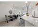 Open concept dining and living area with modern lighting and breakfast bar at 6212 Kilmer Loop # 202, Golden, CO 80403