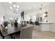 Open-concept living and dining area featuring modern lighting, fireplace, and breakfast bar at 6212 Kilmer Loop # 202, Golden, CO 80403