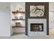 Modern living room detail: fireplace, floating shelves, and decorative art at 6212 Kilmer Loop # 202, Golden, CO 80403