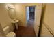 Bathroom with pedestal sink, toilet, and access to stairs at 10129 Grove Ct # B, Westminster, CO 80031