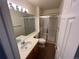 Clean bathroom with a single sink and enclosed shower with glass doors at 10129 Grove Ct # B, Westminster, CO 80031