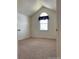 Cozy bedroom with a unique window and vaulted ceiling, creating a bright and airy atmosphere at 10129 Grove Ct # B, Westminster, CO 80031