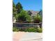 Inviting community entrance with lush landscaping, decorative stone signage and well-maintained surroundings at 10129 Grove Ct # B, Westminster, CO 80031