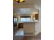 Bright kitchen with modern appliances, wood cabinets, and a convenient breakfast bar area at 10129 Grove Ct # B, Westminster, CO 80031