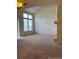 Spacious living room featuring a vaulted ceiling, large windows, and a cozy fireplace at 10129 Grove Ct # B, Westminster, CO 80031