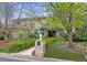 Charming two-story brick home with a lush, landscaped front yard and a stone mailbox at 4070 S Hudson Way, Englewood, CO 80113
