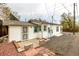 Back exterior featuring a small patio and stone landscaping at 3001 Benton St, Wheat Ridge, CO 80214
