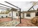 Backyard area with patio, pergola, chairs and hardscape, creating a cozy outdoor living space at 3001 Benton St, Wheat Ridge, CO 80214