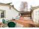 Backyard showing multiple outdoor living spaces including a brick patio, pergola, and green chairs at 3001 Benton St, Wheat Ridge, CO 80214