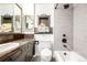 Updated bathroom with dark wood vanity and tiled shower with built-in niche at 3001 Benton St, Wheat Ridge, CO 80214