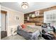 Bedroom with a wood accent wall, tan walls, and white trim and accents at 3001 Benton St, Wheat Ridge, CO 80214