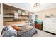 Bedroom with rustic wood accent wall and white dresser and a window to let the light in at 3001 Benton St, Wheat Ridge, CO 80214