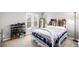 Bright bedroom with light-colored walls, a shoe rack and a metal-frame bed at 3001 Benton St, Wheat Ridge, CO 80214