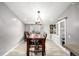 Bright dining room with built-in cabinet and dining table under a chandelier at 3001 Benton St, Wheat Ridge, CO 80214