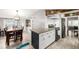 Bright kitchen with island, stainless steel appliances and dining area with charming decor at 3001 Benton St, Wheat Ridge, CO 80214
