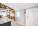 A bright kitchen with rustic wood trim, wood cabinets and a view into another room at 3001 Benton St, Wheat Ridge, CO 80214