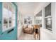 Charming sunroom with a comfortable chair and many windows, perfect for relaxing and enjoying natural light at 3001 Benton St, Wheat Ridge, CO 80214