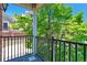 View from balcony overlooking mature tree and garage at 5426 Dtc Pkwy, Greenwood Village, CO 80111