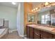 Ensuite bathroom with double sinks, a tub, and separate shower area at 5426 Dtc Pkwy, Greenwood Village, CO 80111