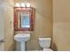 Charming powder room featuring a pedestal sink, decorative mirror, and neutral wall color at 5426 Dtc Pkwy, Greenwood Village, CO 80111