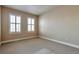Neutral bedroom features carpeted floors, neutral walls, bright white trim, and a pair of shuttered windows at 5426 Dtc Pkwy, Greenwood Village, CO 80111