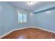 A cozy bedroom with hardwood floors, plantation shutters, and a fresh coat of paint at 5426 Dtc Pkwy, Greenwood Village, CO 80111
