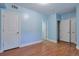 Bright bedroom with hardwood floors, ample closet space, and fresh light-blue paint at 5426 Dtc Pkwy, Greenwood Village, CO 80111