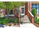 Close-up of townhome front door with stone steps, lovely landscaping and updated exterior fixtures at 5426 Dtc Pkwy, Greenwood Village, CO 80111