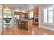 Bright and airy kitchen with stainless steel appliances, hardwood floors, and a functional island at 5426 Dtc Pkwy, Greenwood Village, CO 80111