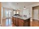 Open-concept space features a spacious kitchen island with gas cooktop and breakfast bar seating at 5426 Dtc Pkwy, Greenwood Village, CO 80111
