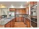 Well-equipped kitchen boasts stainless steel appliances, granite countertops and dark wood cabinetry at 5426 Dtc Pkwy, Greenwood Village, CO 80111