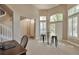 Open-concept living room with a high ceiling, tall windows, and neutral-toned carpeting at 5426 Dtc Pkwy, Greenwood Village, CO 80111