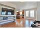 Open living area with hardwood floors, a media niche, and a view into the kitchen at 5426 Dtc Pkwy, Greenwood Village, CO 80111